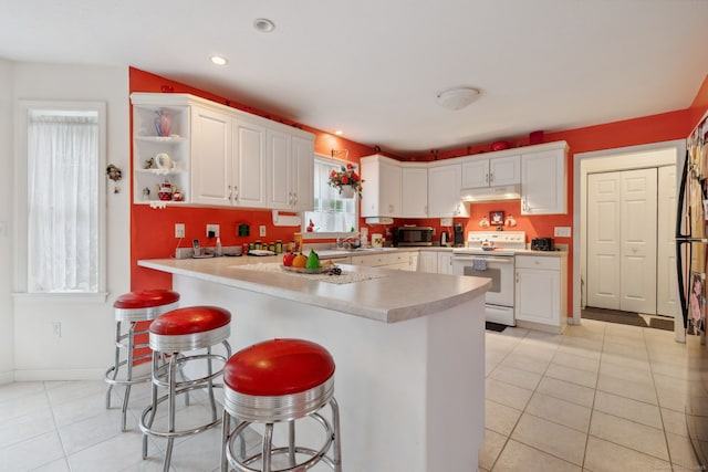 63 Old Cider Mill Rd, Southington, CT 06489 - kitchen featuring white range with electric cooktop, under cabinet range hood, stainless steel microwave, white cabinets, and recessed lighting