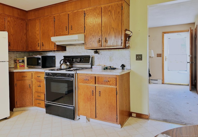 100 Arcadia Ave, Stratford, CT 06614 - kitchen featuring under cabinet range hood, electric range oven, stainless steel microwave, light countertops, and light flooring