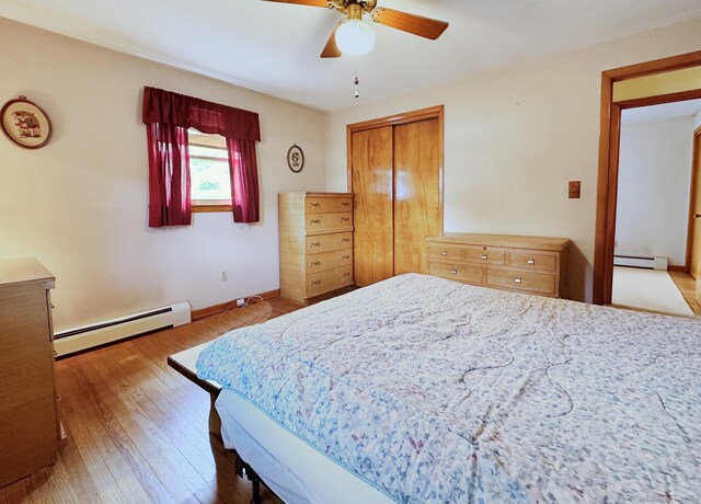 100 Arcadia Ave, Stratford, CT 06614 - bedroom with a baseboard heating unit, wood finished floors, a closet, and baseboards