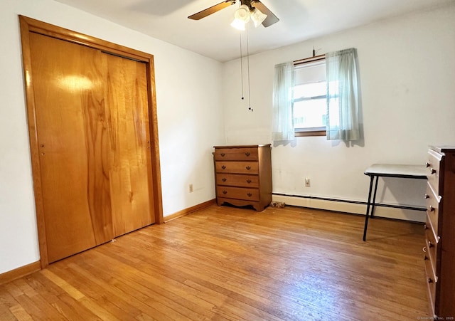 100 Arcadia Ave, Stratford, CT 06614 - bedroom featuring a baseboard heating unit, light wood-style floors, baseboards, a closet, and a ceiling fan