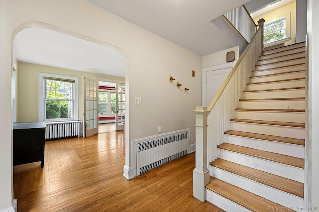 33 Bellevue Pl, Middletown, CT 06457 - stairway with radiator heating unit, arched walkways, and wood-type flooring