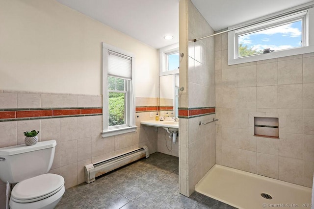 33 Bellevue Pl, Middletown, CT 06457 - bathroom featuring a baseboard radiator, tile walls, tiled shower, plenty of natural light, and a wainscoted wall