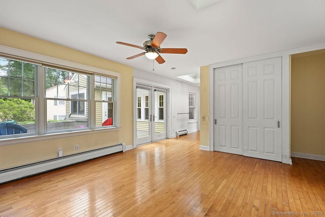 33 Bellevue Pl, Middletown, CT 06457 - unfurnished bedroom with a baseboard heating unit, baseboard heating, light wood-style floors, baseboards, and french doors