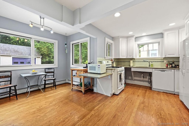 33 Bellevue Pl, Middletown, CT 06457 - kitchen featuring white appliances, white cabinets, light wood-type flooring, backsplash, and a sink