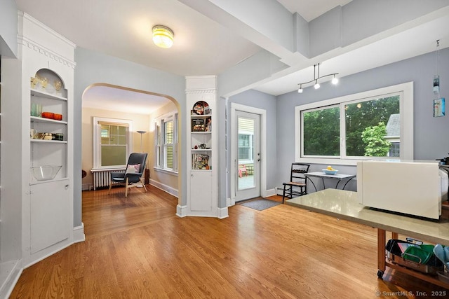 33 Bellevue Pl, Middletown, CT 06457 - foyer with arched walkways, wood finished floors, baseboards, radiator, and a baseboard heating unit