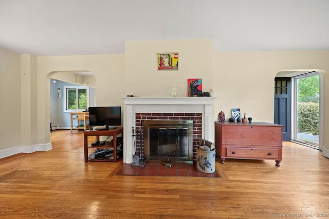 33 Bellevue Pl, Middletown, CT 06457 - living room featuring arched walkways, wood-type flooring, and a fireplace with flush hearth