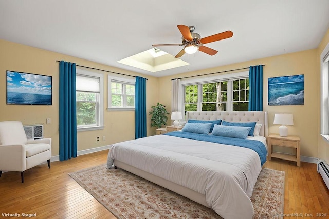 33 Bellevue Pl, Middletown, CT 06457 - bedroom with light wood-style floors, baseboards, a baseboard radiator, and a skylight