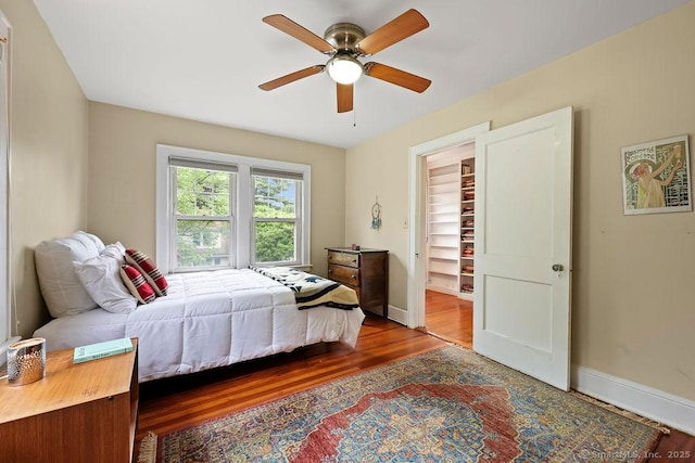 33 Bellevue Pl, Middletown, CT 06457 - bedroom featuring wood finished floors, baseboards, a spacious closet, and a ceiling fan
