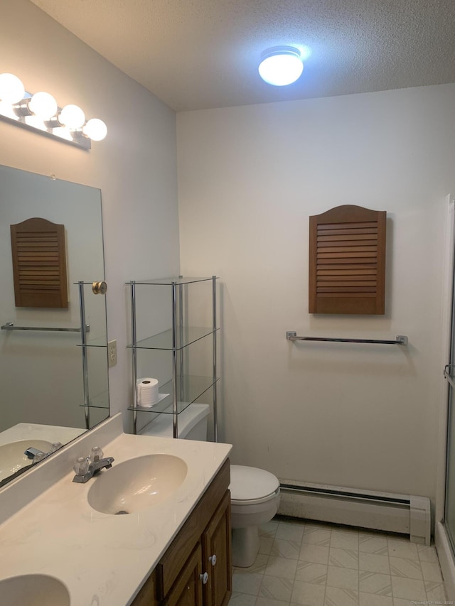 58 Amanda Cir, Windsor, CT 06095 - full bathroom with a baseboard radiator, toilet, double vanity, a textured ceiling, and an enclosed shower