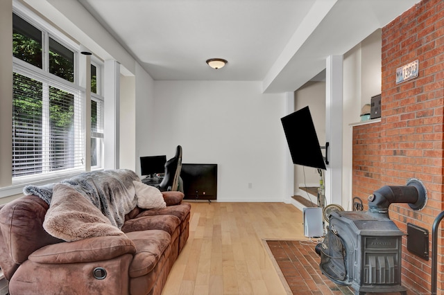 4 Pepperidge Ct Unit 4, Simsbury, CT 06070 - living room with hardwood / wood-style floors, a wood stove, and baseboards