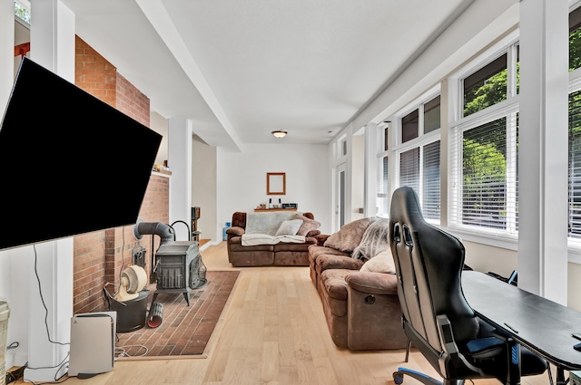 4 Pepperidge Ct Unit 4, Simsbury, CT 06070 - living area featuring a wood stove, plenty of natural light, light wood-style floors, and a desk