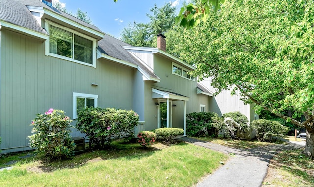 4 Pepperidge Ct Unit 4, Simsbury, CT 06070 - view of exterior entry with a chimney and roof with shingles