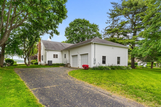 8 Wadsworth Ln, Waterford, CT 06385 - view of front of home featuring asphalt driveway, a front yard, cooling unit, a garage, and a shingled roof