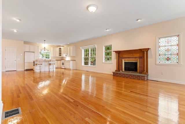 8 Wadsworth Ln, Waterford, CT 06385 - unfurnished living room featuring light wood finished floors, a fireplace, baseboards, and recessed lighting