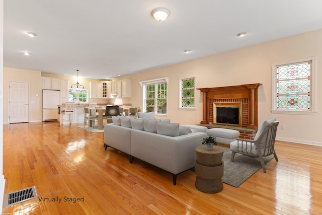 8 Wadsworth Ln, Waterford, CT 06385 - living room with light wood-style floors, a fireplace, baseboards, and recessed lighting