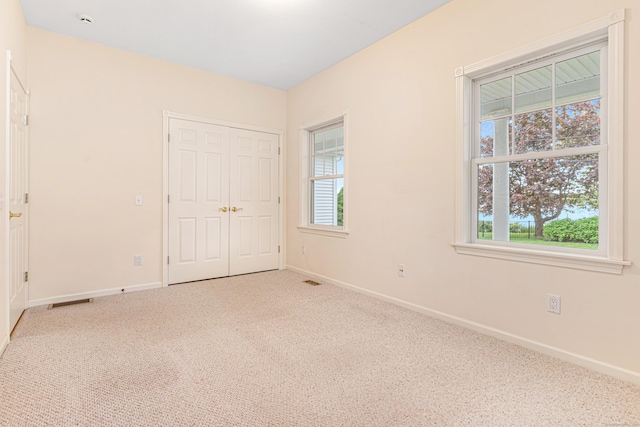 8 Wadsworth Ln, Waterford, CT 06385 - unfurnished bedroom featuring carpet, baseboards, and multiple windows