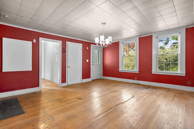 19 Elm St, Ansonia, CT 06401 - empty room featuring a chandelier, hardwood / wood-style floors, and baseboards