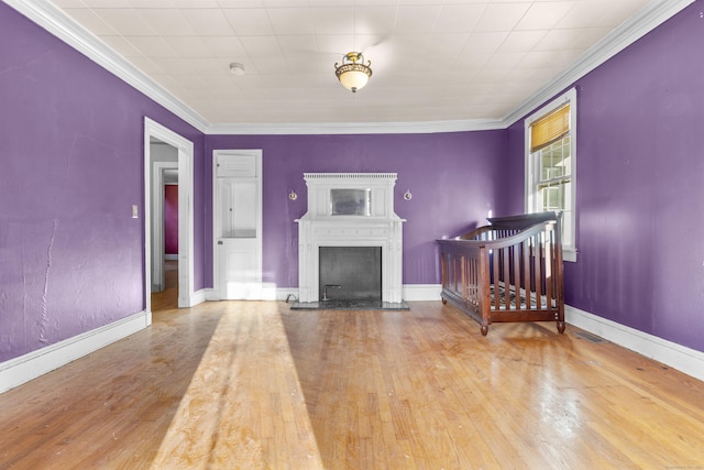 19 Elm St, Ansonia, CT 06401 - living room with ornamental molding, wood finished floors, baseboards, and a fireplace with raised hearth