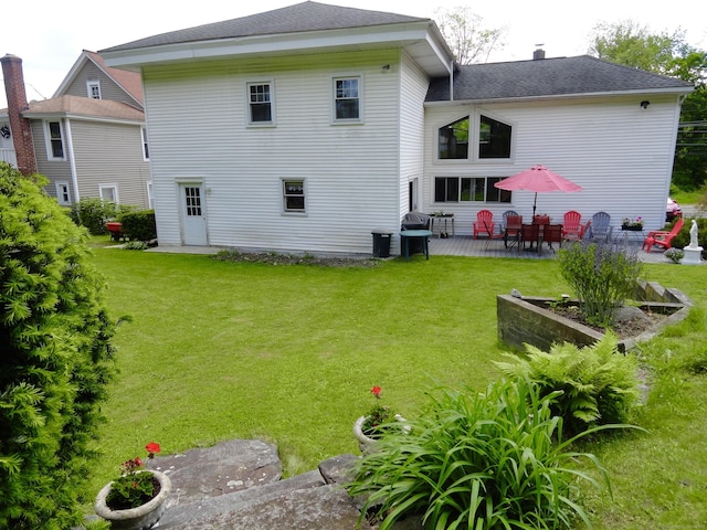 409 N Main St, Winchester, CT 06098 - rear view of house featuring a patio area, a lawn, a chimney, and roof with shingles