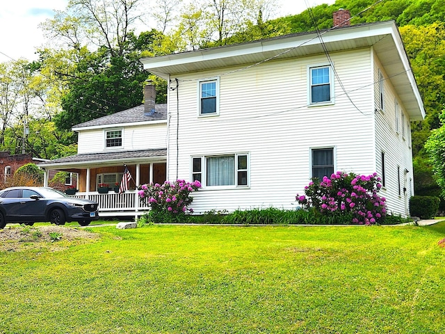 409 N Main St, Winchester, CT 06098 - view of front of house featuring a chimney, a porch, and a front lawn