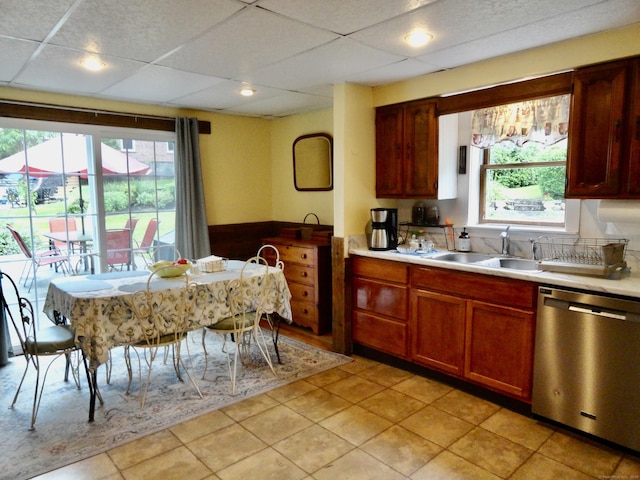 409 N Main St, Winchester, CT 06098 - kitchen with dishwasher, light countertops, a drop ceiling, and light tile patterned flooring