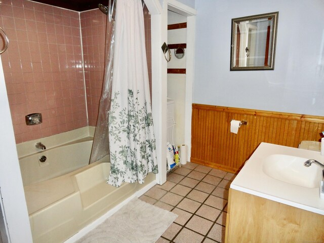 409 N Main St, Winchester, CT 06098 - bathroom featuring wainscoting, shower / bath combo with shower curtain, tile patterned floors, vanity, and wood walls