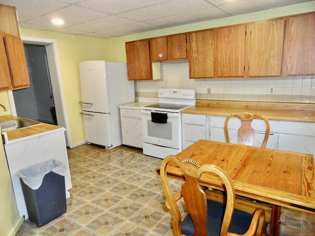 409 N Main St, Winchester, CT 06098 - kitchen featuring white appliances, backsplash, light countertops, and recessed lighting