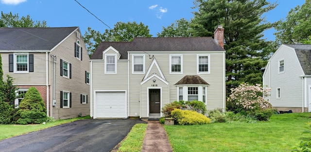 1815 Asylum Ave, West Hartford, CT 06117 - view of front of house with asphalt driveway, a chimney, an attached garage, and a front lawn