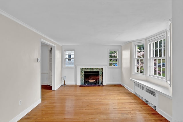 1815 Asylum Ave, West Hartford, CT 06117 - unfurnished living room featuring radiator heating unit, a fireplace with flush hearth, light wood finished floors, and crown molding