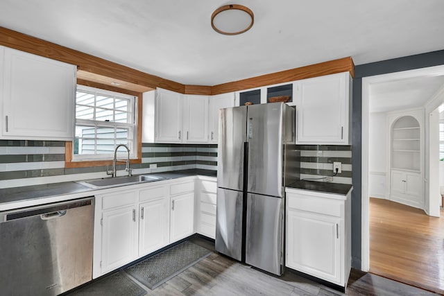 1815 Asylum Ave, West Hartford, CT 06117 - kitchen featuring appliances with stainless steel finishes, white cabinets, backsplash, and wood finished floors