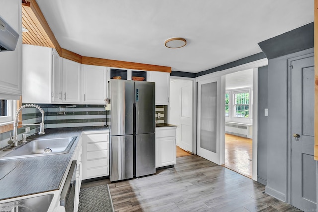 1815 Asylum Ave, West Hartford, CT 06117 - kitchen featuring freestanding refrigerator, radiator, white cabinets, dark countertops, and tasteful backsplash