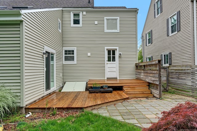 1815 Asylum Ave, West Hartford, CT 06117 - back of property with a deck, a patio area, a shingled roof, and a chimney