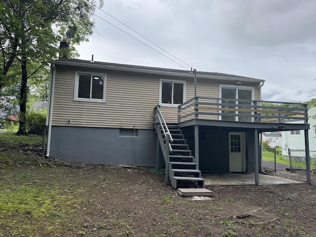 256 Alexander Rd, New Britain, CT 06053 - back of property featuring a wooden deck, stairway, and a patio