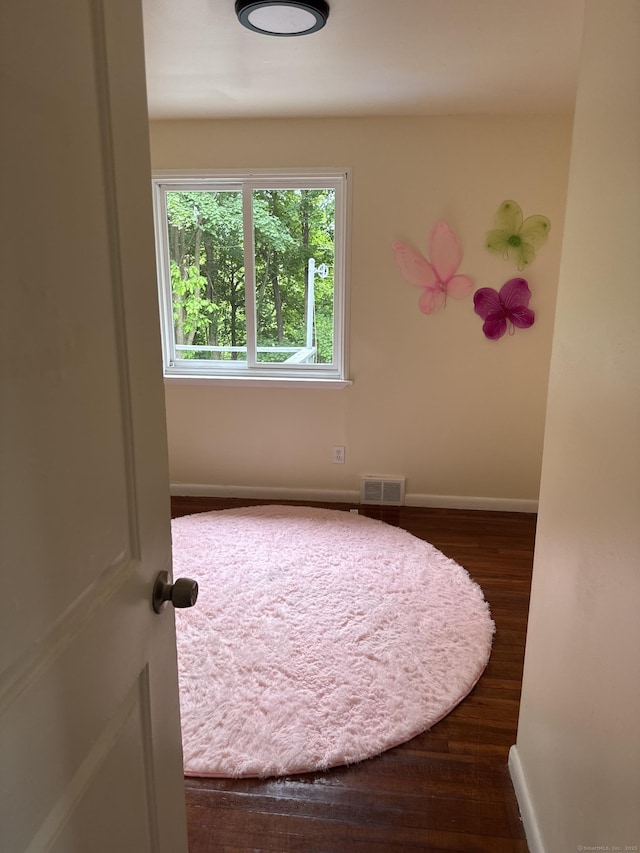 256 Alexander Rd, New Britain, CT 06053 - spare room with baseboards and dark wood-type flooring