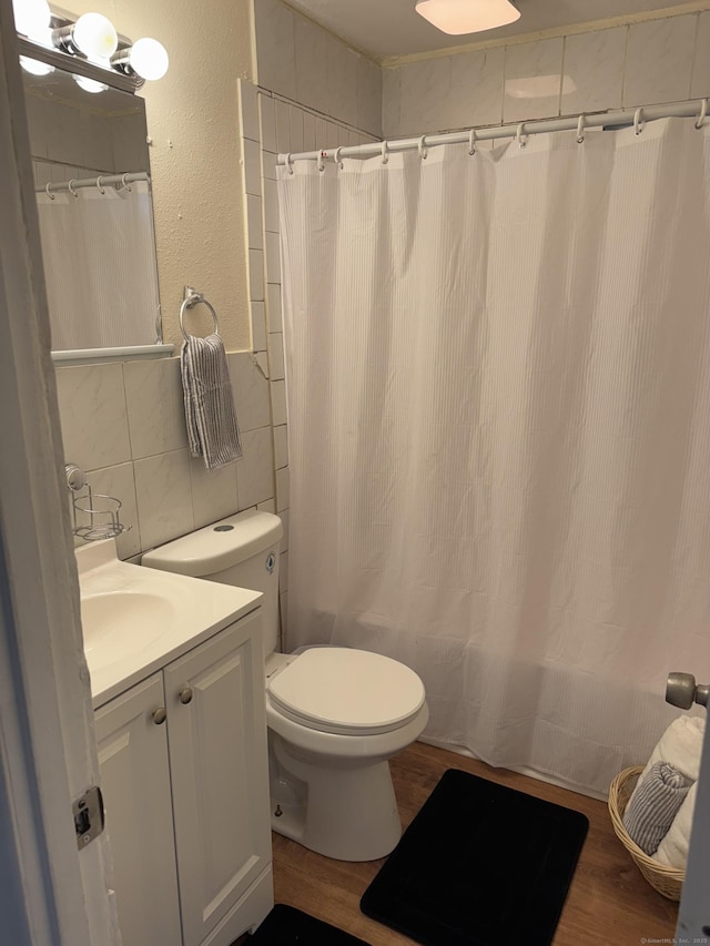 256 Alexander Rd, New Britain, CT 06053 - full bath featuring toilet, vanity, tile walls, wood finished floors, and shower / bath combo
