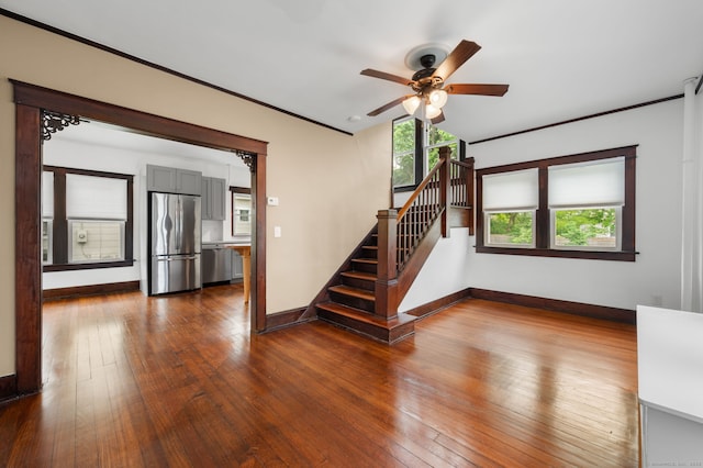 58 Gorton St, New London, CT 06320 - unfurnished living room with baseboards, a ceiling fan, stairway, dark wood finished floors, and ornamental molding