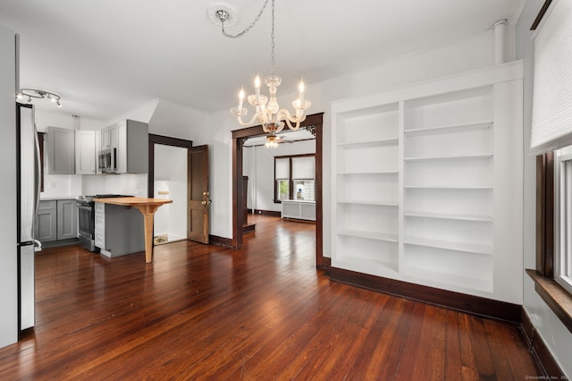 58 Gorton St, New London, CT 06320 - unfurnished dining area with a chandelier, dark wood finished floors, baseboards, and built in features