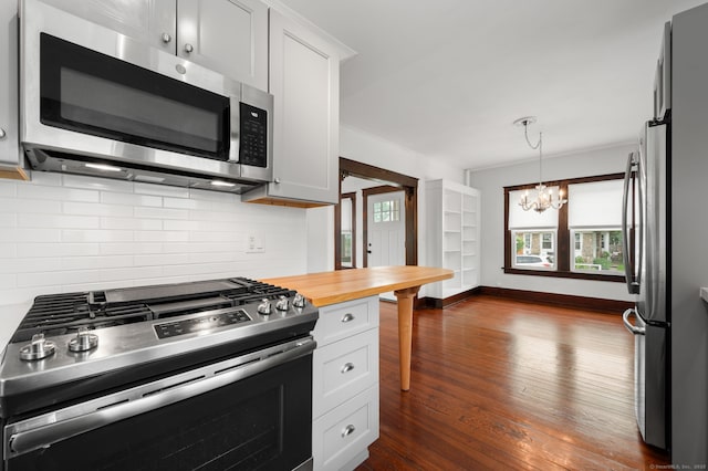 58 Gorton St, New London, CT 06320 - kitchen with appliances with stainless steel finishes, a chandelier, decorative backsplash, dark wood-style flooring, and butcher block countertops