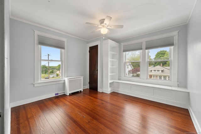 58 Gorton St, New London, CT 06320 - empty room with radiator, ornamental molding, dark wood finished floors, ceiling fan, and built in shelves