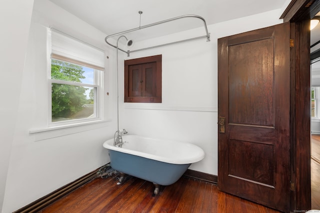 58 Gorton St, New London, CT 06320 - bathroom with a freestanding bath, wood finished floors, and baseboards