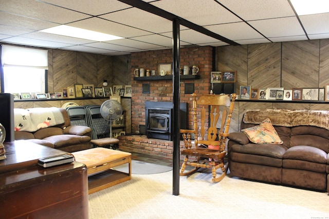 243 Courtland Ave, Waterbury, CT 06705 - living area with a paneled ceiling, a wood stove, and wooden walls