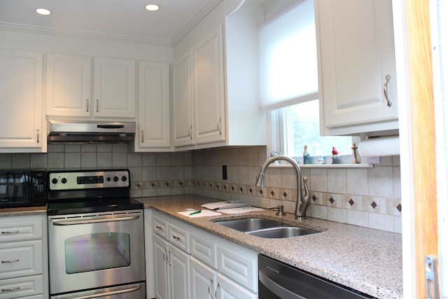 243 Courtland Ave, Waterbury, CT 06705 - kitchen featuring appliances with stainless steel finishes, under cabinet range hood, a sink, white cabinets, and recessed lighting