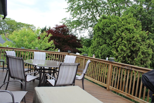 243 Courtland Ave, Waterbury, CT 06705 - wooden deck featuring outdoor dining area and view of wooded area