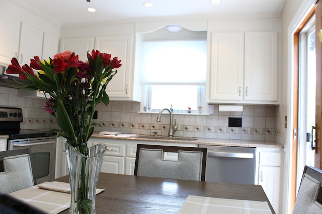 243 Courtland Ave, Waterbury, CT 06705 - kitchen with appliances with stainless steel finishes, a sink, white cabinets, plenty of natural light, and recessed lighting