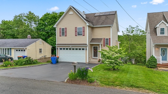 74 Avery Ave, Meriden, CT 06450 - traditional-style house featuring driveway, a garage, a front yard, solar panels, and roof with shingles