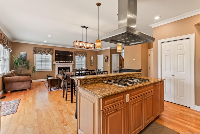 74 Avery Ave, Meriden, CT 06450 - kitchen featuring island range hood, stainless steel gas stovetop, open floor plan, crown molding, and light wood finished floors