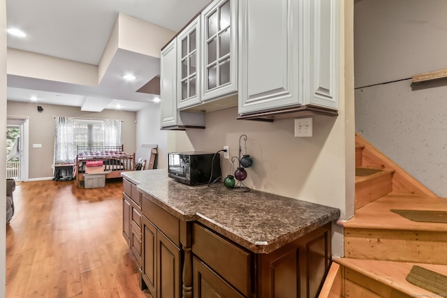 74 Avery Ave, Meriden, CT 06450 - kitchen with glass insert cabinets, light wood finished floors, black microwave, and recessed lighting
