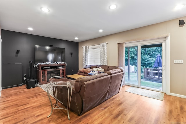 74 Avery Ave, Meriden, CT 06450 - living room featuring light wood-style floors, recessed lighting, a glass covered fireplace, and baseboards