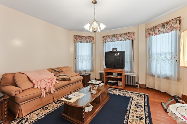30 Newton St, Hartford, CT 06106 - living area featuring radiator heating unit, a chandelier, and wood finished floors