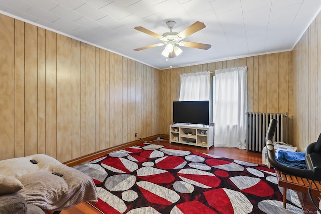 30 Newton St, Hartford, CT 06106 - living area with radiator, ceiling fan, wood finished floors, wood walls, and ornamental molding